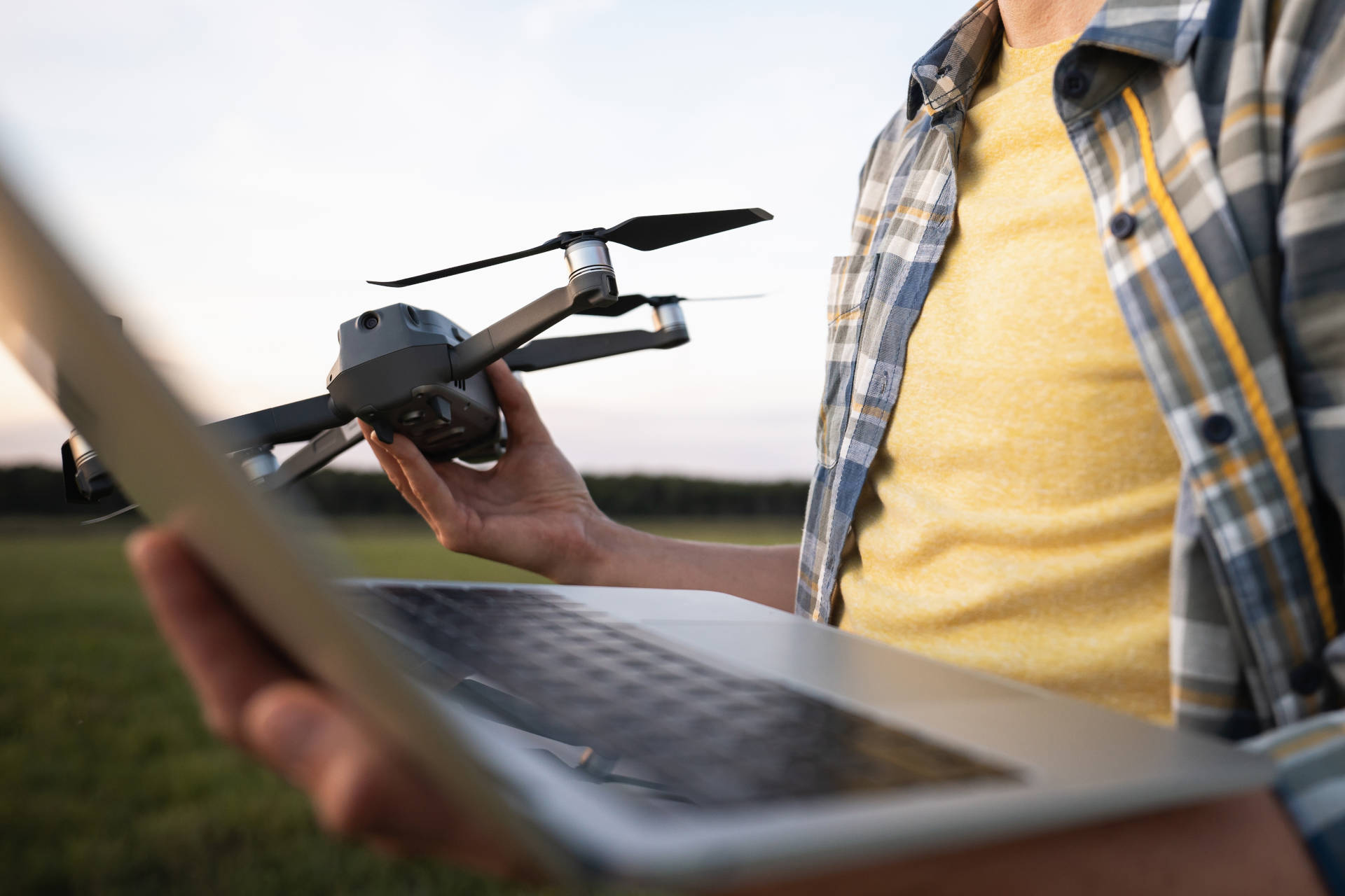 Man holding drone and laptop